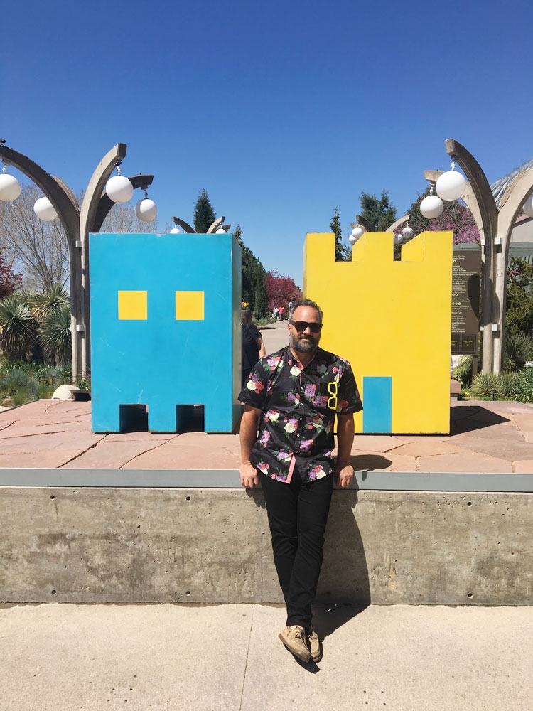 mike whiting in front of his scupltures