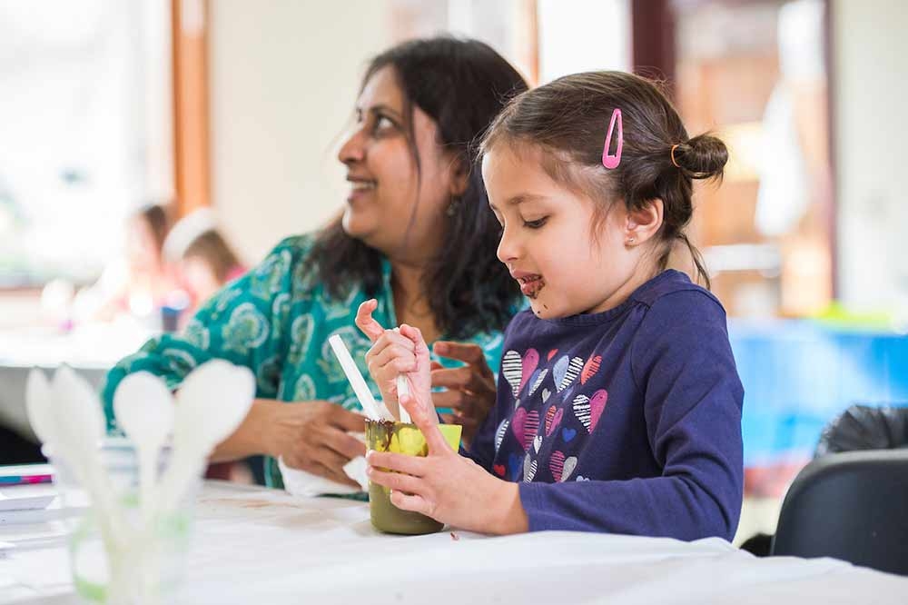 Adult and child creating a craft together