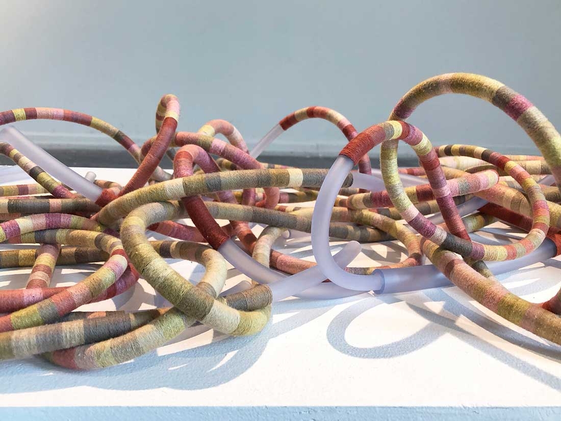 Tali Weinberg, "Bound," petrochemical-derived medical tubing, plant fibers, plant and insect dyes, 2024. 