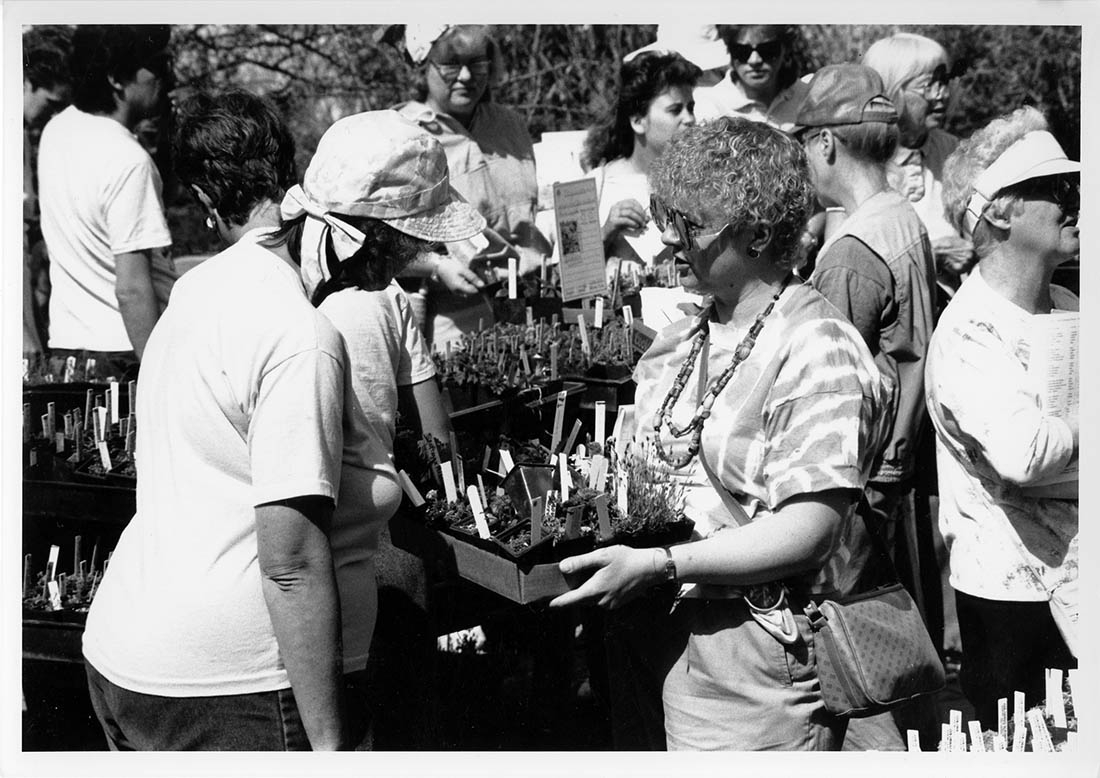 black and white photo two women shopping plant sale