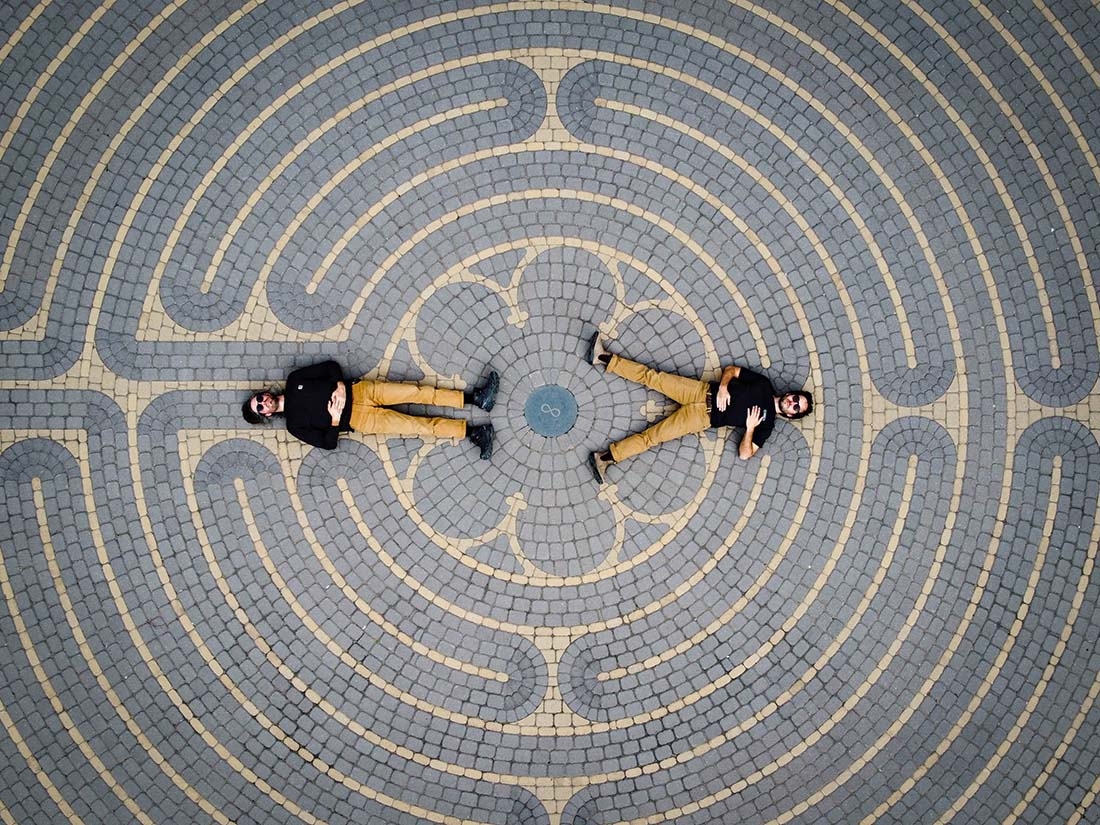 Authors laying on a labyrinth design