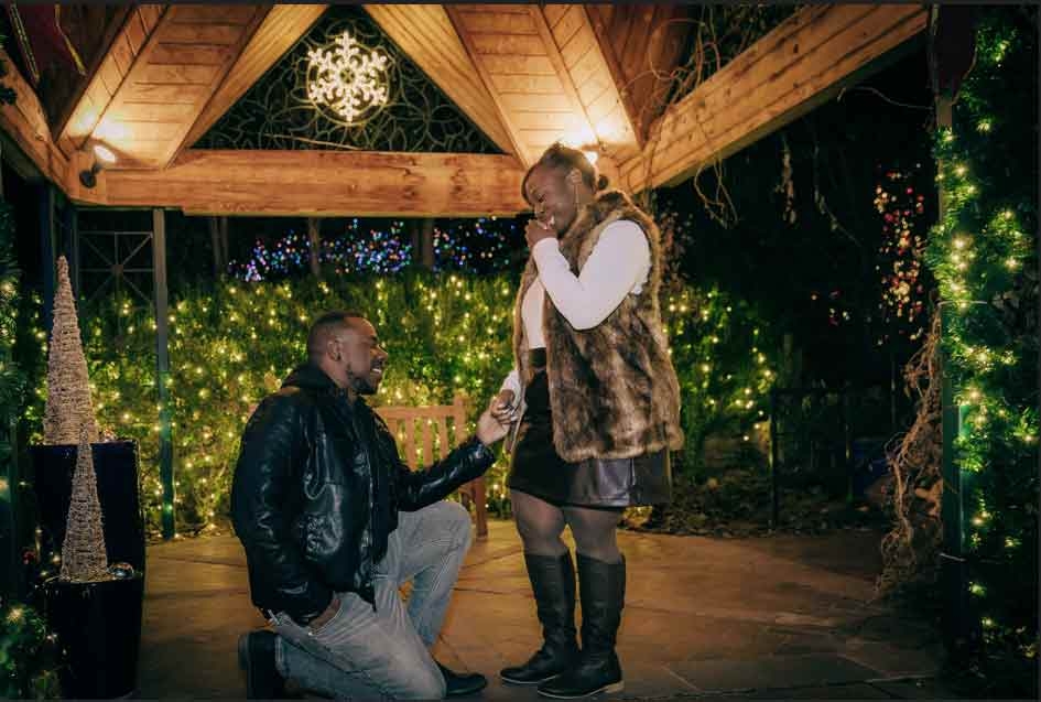 Two people getting engaged in the gazebo in the enchanting Victorian Secret Garden