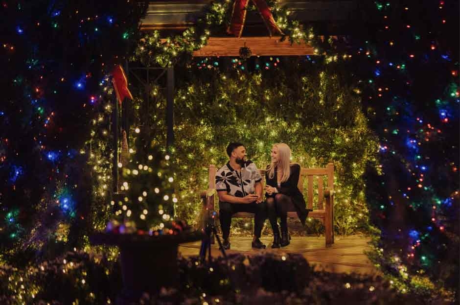 Two people getting engaged in the gazebo in the enchanting Victorian Secret Garden