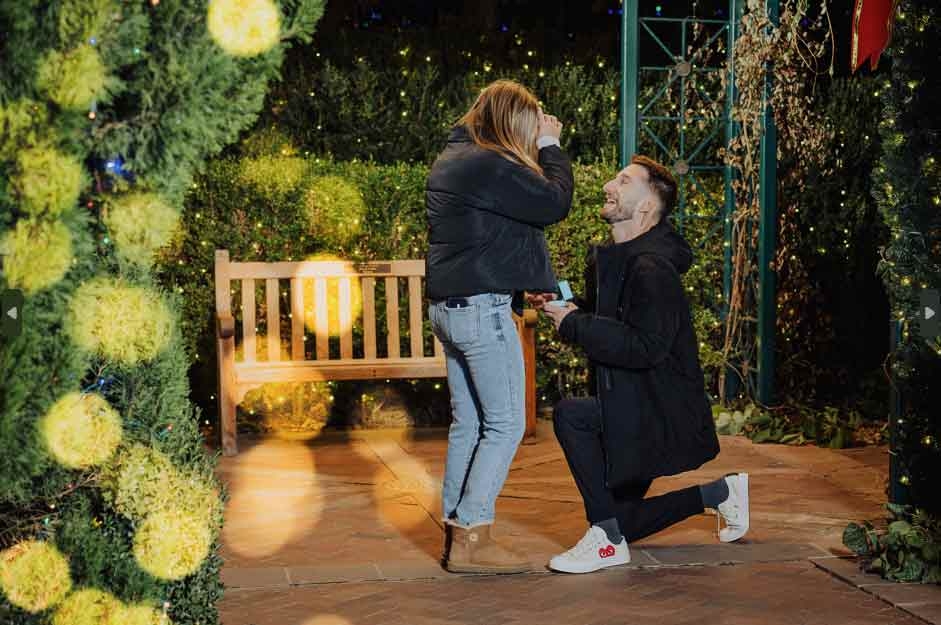 Two people getting engaged in the gazebo in the enchanting Victorian Secret Garden