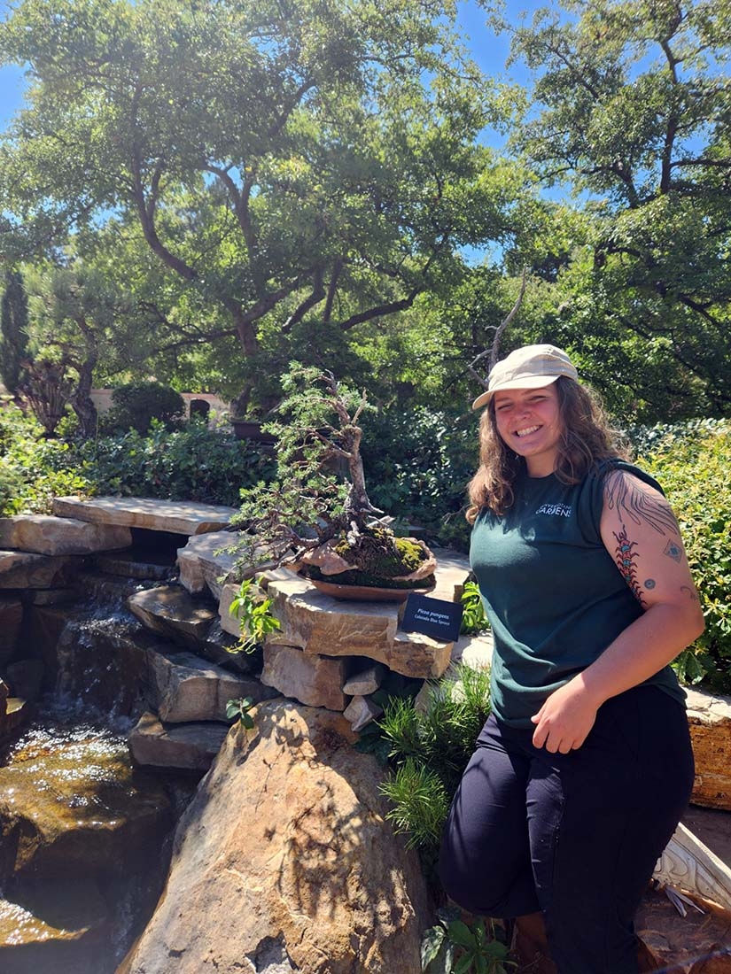 Hunter posing with bonsai tree