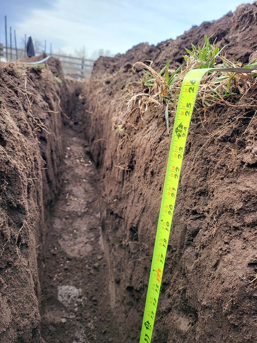 Dirt trench with measuring tape
