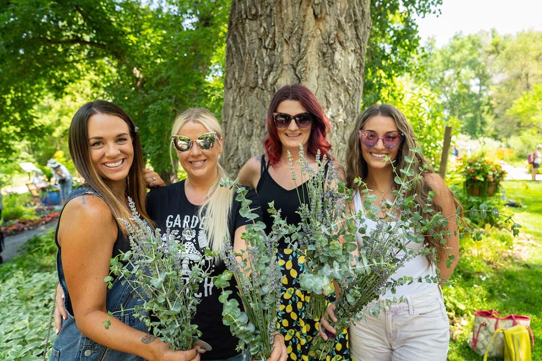 Four women holding bouquets