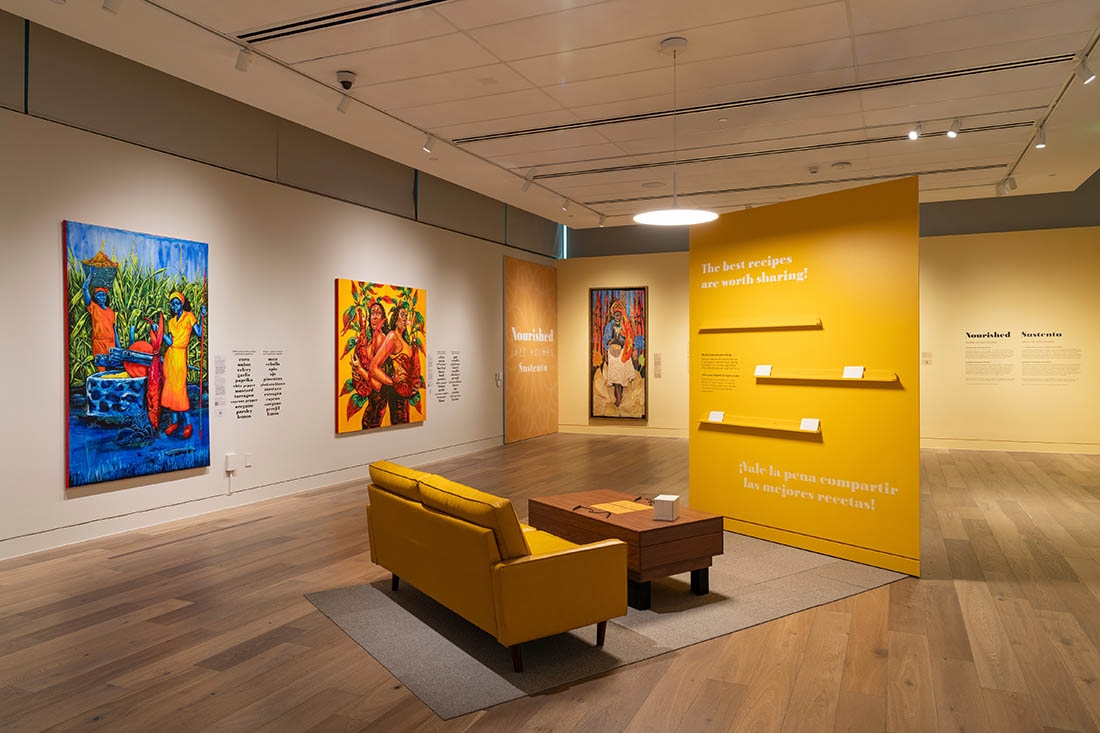 art gallery with yellow accent wall and matching couch