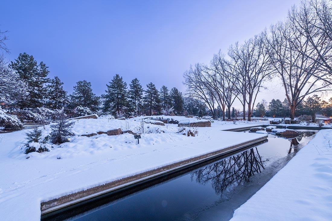 Snow and a waterway with a bright blue sky