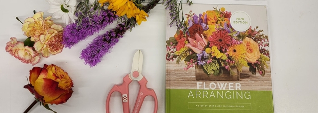 Dried flowers, a book cover and scissors